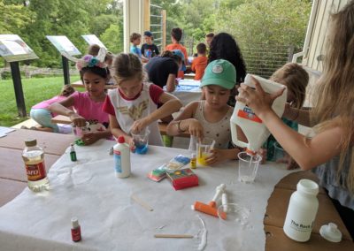 Campers at the Howard County Conservancy's Summer Nature Camp experiment with different types of slime.