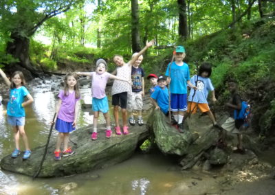 Campers from Howard County Conservancy's Summer Nature Camp at Mt. Pleasant across the Davis Branch stream